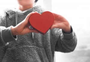 boy holding a heart object