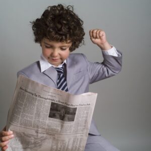 kid reading newspaper