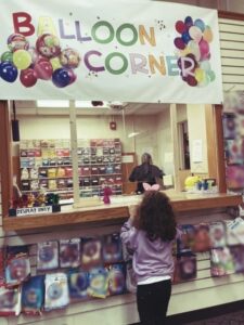 kid buying balloons